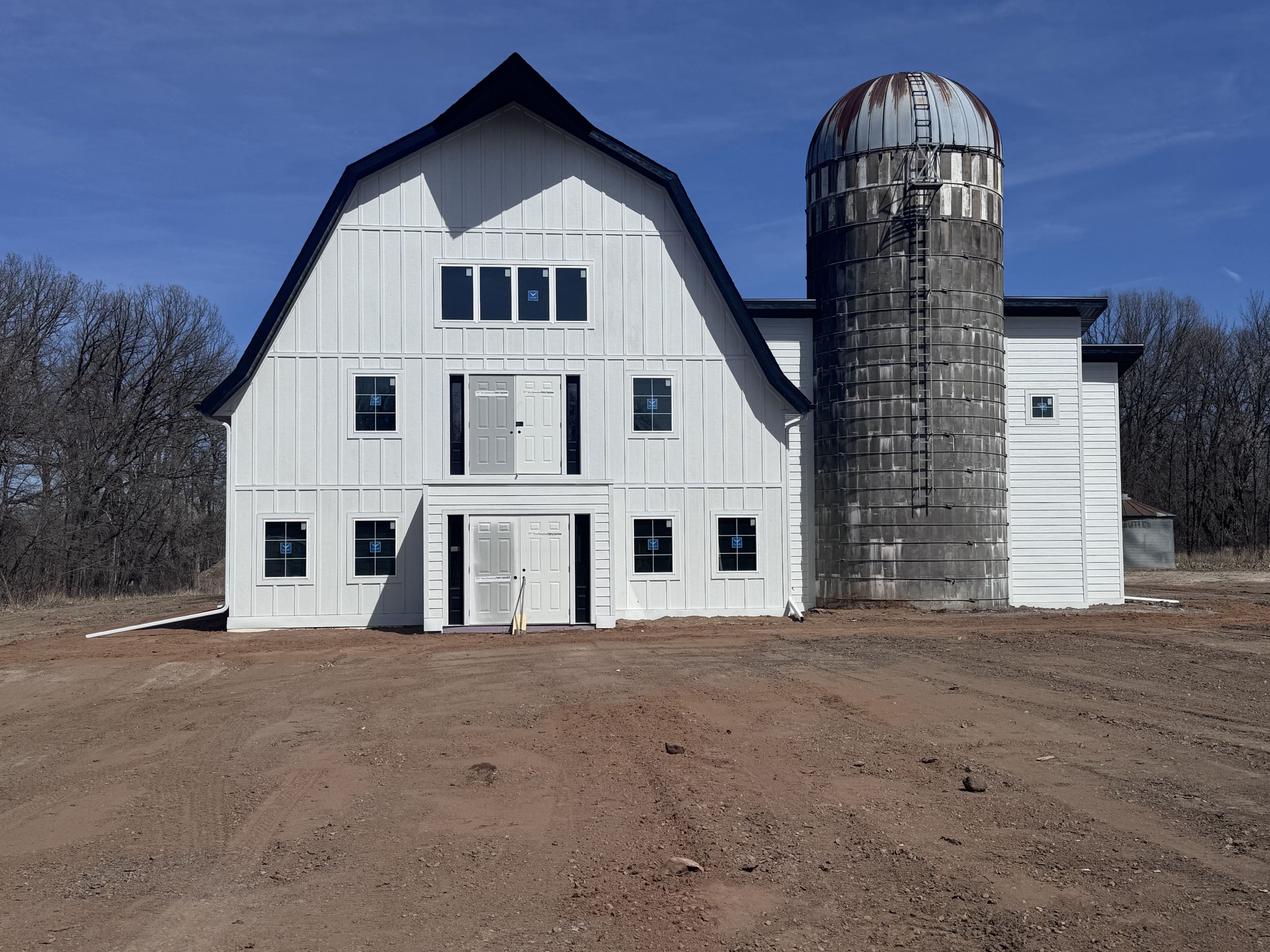 White barn and silo with fresh exterior finish